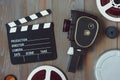 Clapperboard, old movie camera and coils with movies Royalty Free Stock Photo