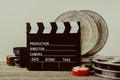 Clapperboard, tin boxes with film and lens