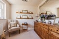 Snug sitting room with armchair and sideboard