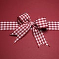 Claret greeting card with red white checked ribbon