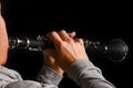 Clarinet in the hands of a man on a black background Royalty Free Stock Photo