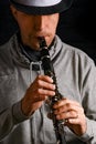 Clarinet in the hands of a man on a black background Royalty Free Stock Photo