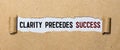 Clarity Precedes Success text on 3 piece of torn paper over green surface Royalty Free Stock Photo