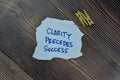 Clarity Precedess Success write on sticky notes isolated on Wooden Table