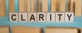 Clarity Word In Wooden Cube With Blue Background