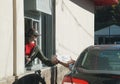 Clark Summit, Pennsylvania, U.S - October 15, 2022 - Customer picking up the order at drive-through lane at Krispy Kreme