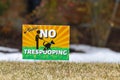 A colorful yard sign on the front yard of a house says Please No Trespooping