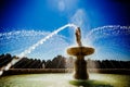 Clasic Fountain with arcing jets of water and blue sky