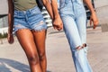 Clasped hands of two young african women walking