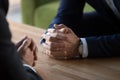 Clasped male hands of two businessmen negotiating at table Royalty Free Stock Photo