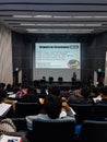 A class full of students listening to lecturers who are teaching