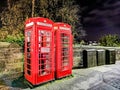 Class Red British Phone both with Edinburgh Castle at night Royalty Free Stock Photo