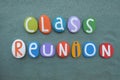 Class Reunion banner composed with multi colored stone letters over green sand