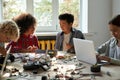 Class in school lab for group of multiracial schoolkids on STEM education.