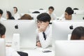 A class of students in front of their screens study computer science.