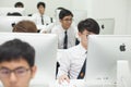 A class of students in front of their screens study computer science.