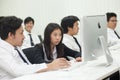A class of students in front of their screens study computer science.
