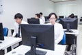 A class of students in front of their screens study computer science.