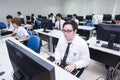 A class of students in front of their screens study computer science.