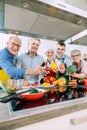 Class in training kitchen learning cooking with nutritionist chef