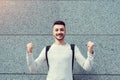 Classes canceled. Happy arabian student outside. Successful and confident young man raised hands. Royalty Free Stock Photo