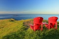 Evening Sun Shining on Red Adirondack Chairs at East Point on Saturna Island, Gulf Islands National Park, British Columbia, Canada Royalty Free Stock Photo