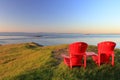 Gulf Islands National Park and Reserve, Red Adirondack Chairs in Evening Light at East Point, Saturna Island, BC, Canada Royalty Free Stock Photo