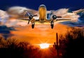 Classic airplane crossing sunset skies over Arizona desert/ Royalty Free Stock Photo