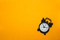 Classic alarm clock on yellow background. vintage watch with round dial Royalty Free Stock Photo