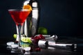 Classic alcoholic cocktail cosmopolitan with vodka, liqueur, cranberry juice, lime, ice and orange zest, dark bar counter Royalty Free Stock Photo