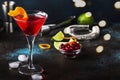 Classic alcoholic cocktail cosmopolitan with vodka, liqueur, cranberry juice, lime, ice and orange zest, dark bar counter Royalty Free Stock Photo