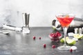 Classic alcoholic cocktail cosmopolitan with vodka, liqueur, cranberry juice, lime, ice and orange zest, gray bar counter Royalty Free Stock Photo