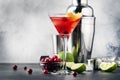 Classic alcoholic cocktail cosmopolitan with vodka, liqueur, cranberry juice, lime, ice and orange zest, gray bar counter Royalty Free Stock Photo