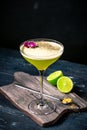 Classic alcoholic cocktail Daiquiri with lime and kiwi in a glass on a black background Royalty Free Stock Photo