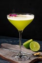 Classic alcoholic cocktail Daiquiri with lime and kiwi in a glass on a black background Royalty Free Stock Photo