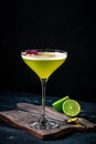 Classic alcoholic cocktail Daiquiri with lime and kiwi in a glass on a black background. Tropical vermouth Royalty Free Stock Photo