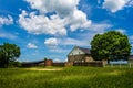 Classic Americam barn in field with large tree Royalty Free Stock Photo