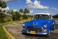 Classic American blue car one of streets in Havana,