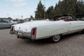 Classic american Cadillac car in store parking. Rear detail of white luxury retro vintage automobile headlight Royalty Free Stock Photo