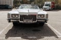 Classic american Cadillac car in store parking. White luxury retro vintage automobile. Front view in low perspective Royalty Free Stock Photo