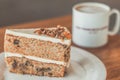 Classic American Carrot Cake with cream cheese frosting and a cup of hot latte