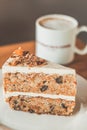 Classic American Carrot Cake with cream cheese frosting and a cup of hot latte