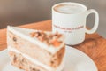 Classic American Carrot Cake with cream cheese frosting and a cup of hot latte