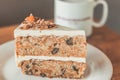 Classic American Carrot Cake with cream cheese frosting and a cup of hot latte