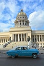 Classic American cars on the road at front of the Capitolio building Royalty Free Stock Photo