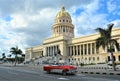 Classic American cars on the road at front of the Capitolio building Royalty Free Stock Photo