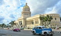 Classic American cars on the road at front of the Capitolio building Royalty Free Stock Photo