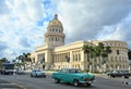 Classic American cars on the road at front of the Capitolio building Royalty Free Stock Photo