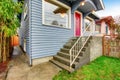 Classic American house exterior with blue trim and red front door Royalty Free Stock Photo