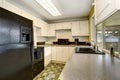 Classic American kitchen romm interior with white wooden cabinets.